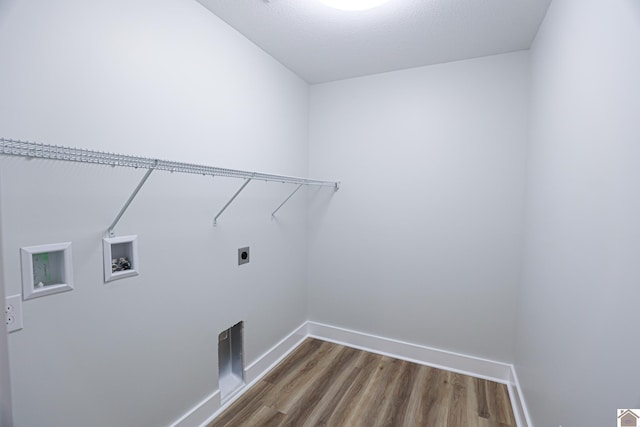 washroom featuring washer hookup, hardwood / wood-style flooring, hookup for an electric dryer, and a textured ceiling