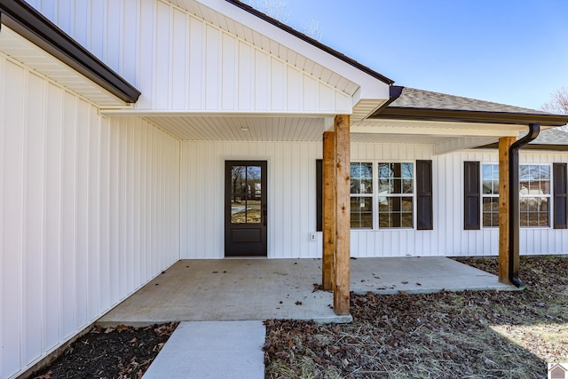 view of exterior entry with a patio area