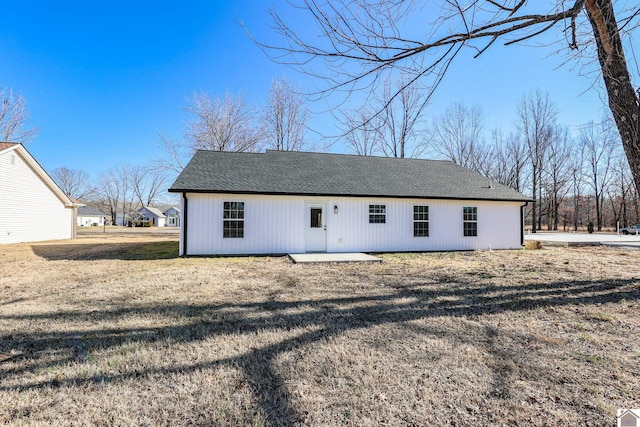 rear view of house featuring a patio area and a lawn