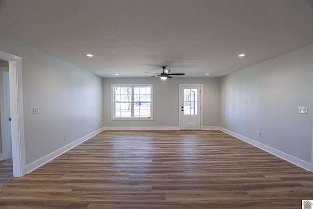 interior space featuring dark wood-type flooring and ceiling fan