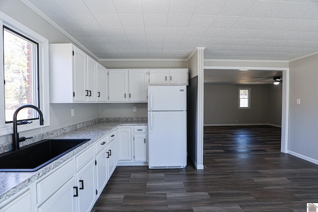 kitchen with sink, crown molding, white refrigerator, ceiling fan, and white cabinets