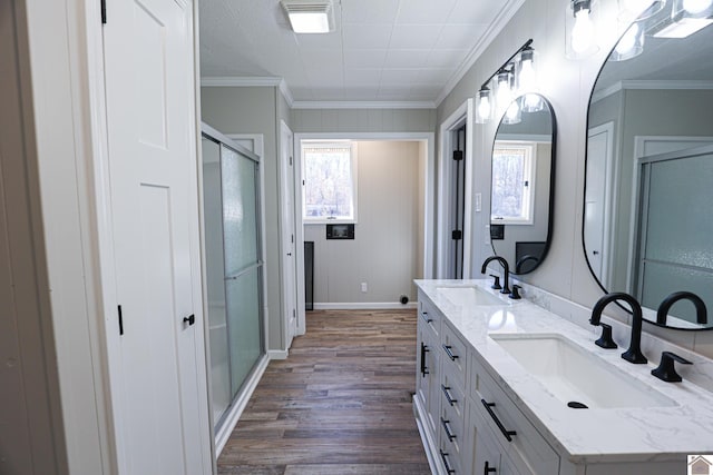 bathroom featuring vanity, hardwood / wood-style floors, crown molding, and a wealth of natural light