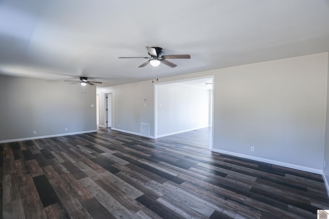 spare room featuring dark wood-type flooring and ceiling fan