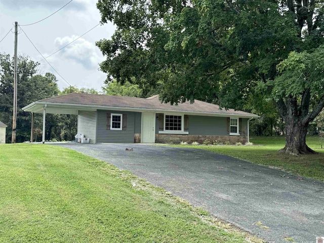 ranch-style house with a front yard and a carport