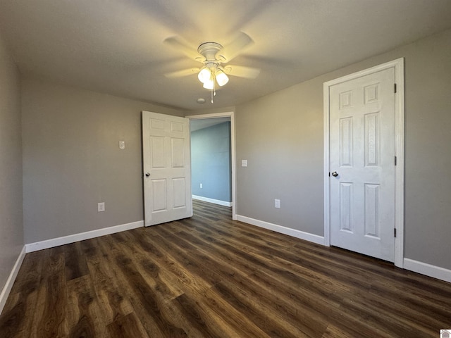 unfurnished bedroom with ceiling fan and dark hardwood / wood-style flooring