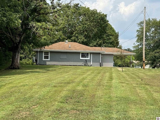 rear view of house featuring a yard