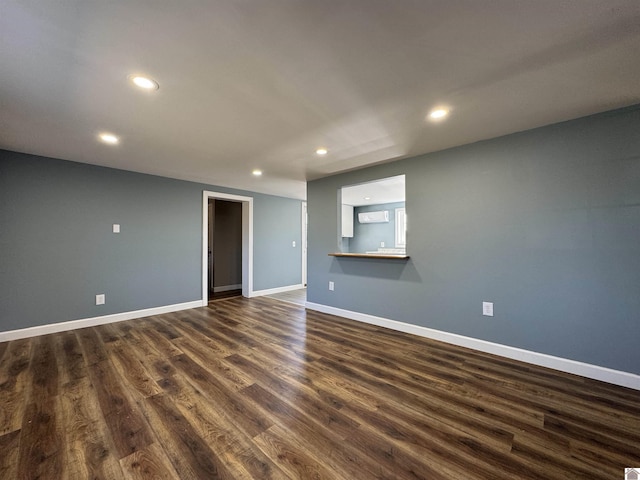 unfurnished room with dark hardwood / wood-style flooring