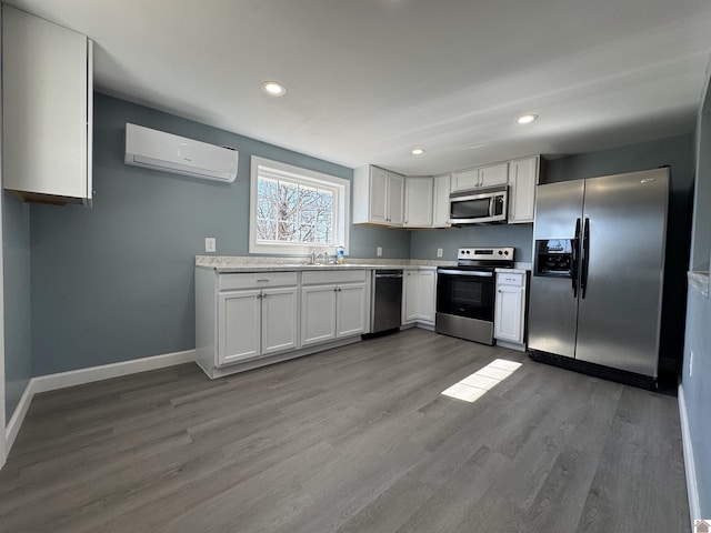 kitchen featuring white cabinetry, appliances with stainless steel finishes, dark wood-type flooring, and a wall mounted AC