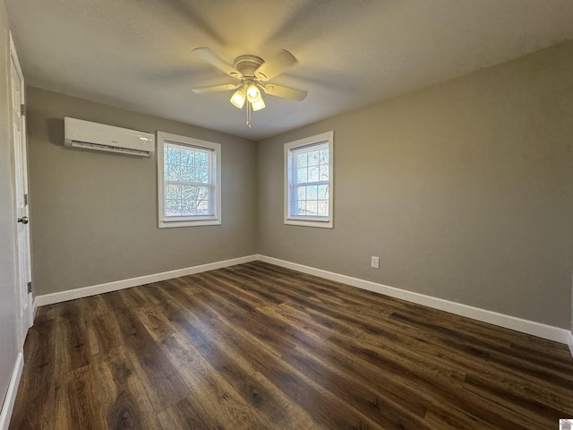 empty room featuring ceiling fan, a wall mounted air conditioner, and dark hardwood / wood-style flooring