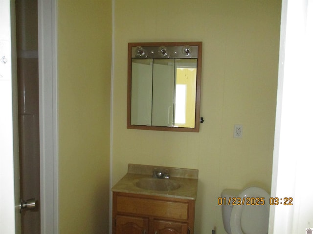 bathroom featuring vanity and toilet