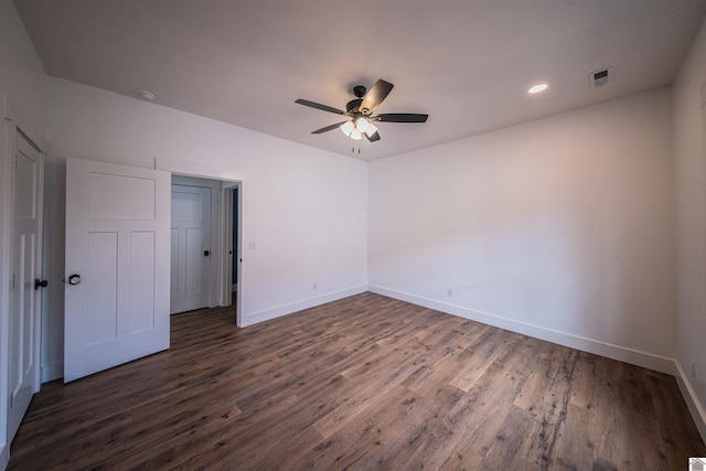 spare room with dark hardwood / wood-style floors and ceiling fan