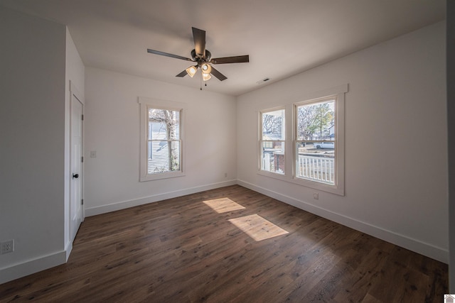 unfurnished room with dark hardwood / wood-style floors and ceiling fan