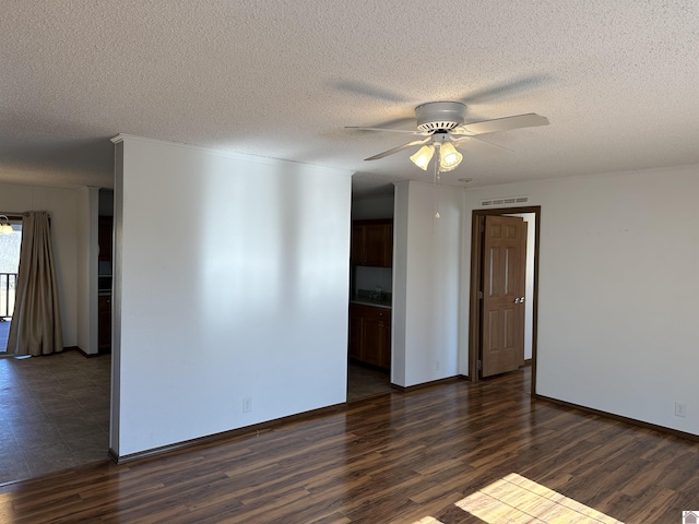 unfurnished room with dark wood-type flooring, ceiling fan, and a textured ceiling