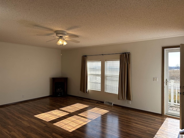 spare room with ceiling fan, dark wood-type flooring, and a textured ceiling