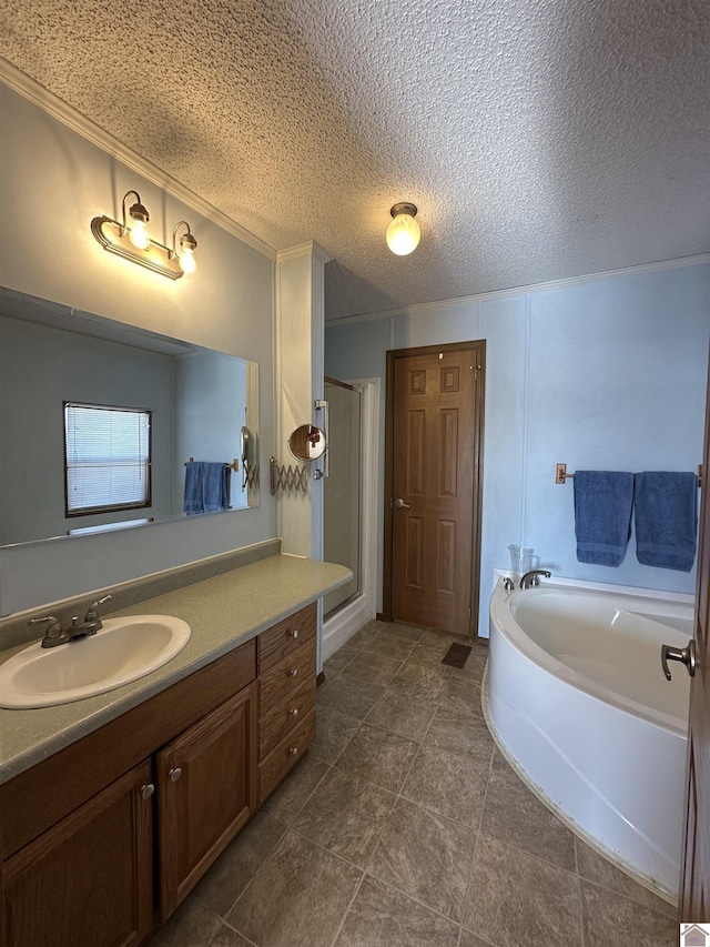 bathroom featuring vanity, independent shower and bath, and a textured ceiling