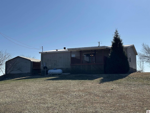 back of house with a lawn