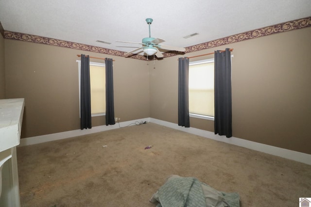 carpeted spare room with ceiling fan