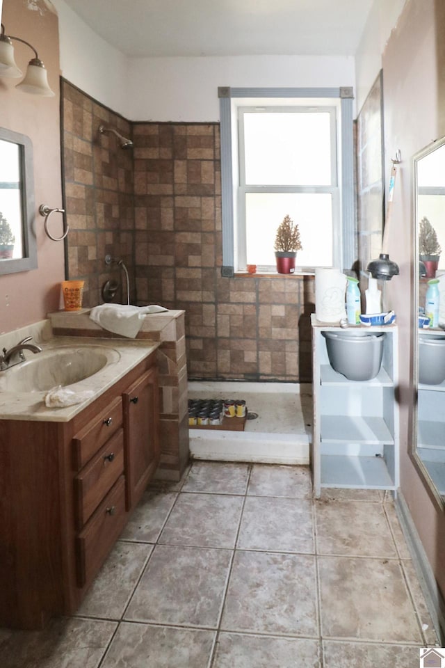 bathroom with walk in shower, vanity, and a wealth of natural light