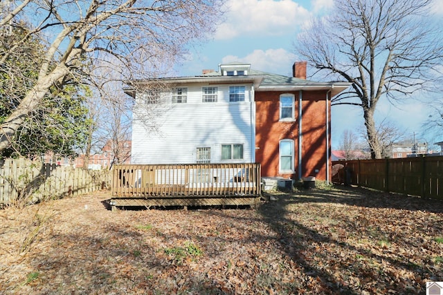 back of house with a deck