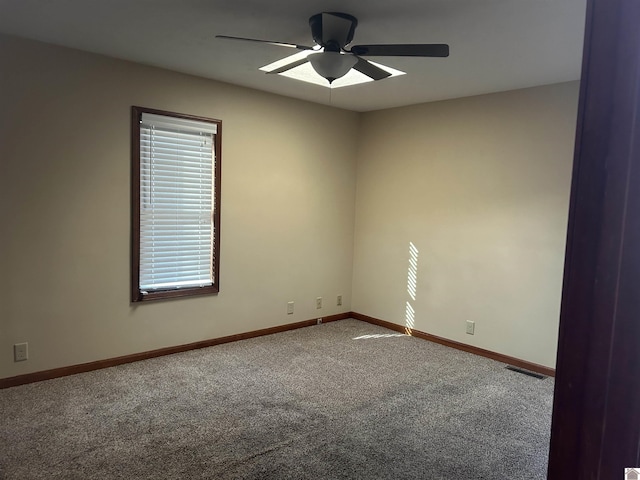 carpeted empty room featuring ceiling fan