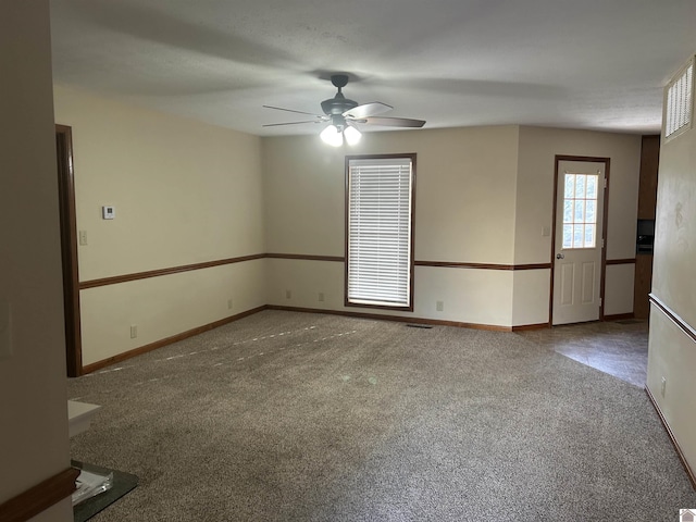 carpeted empty room featuring ceiling fan