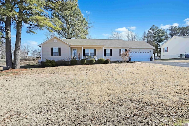 ranch-style house with a garage and covered porch