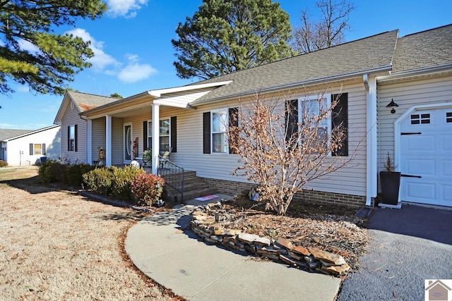 ranch-style house featuring a porch and a garage