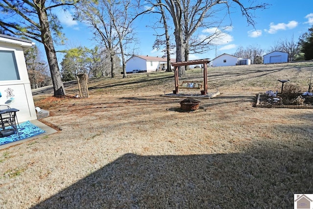 view of yard with an outdoor fire pit and a pergola