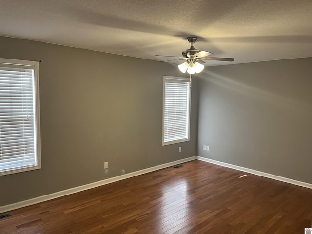 unfurnished room featuring ceiling fan, a textured ceiling, and dark hardwood / wood-style flooring