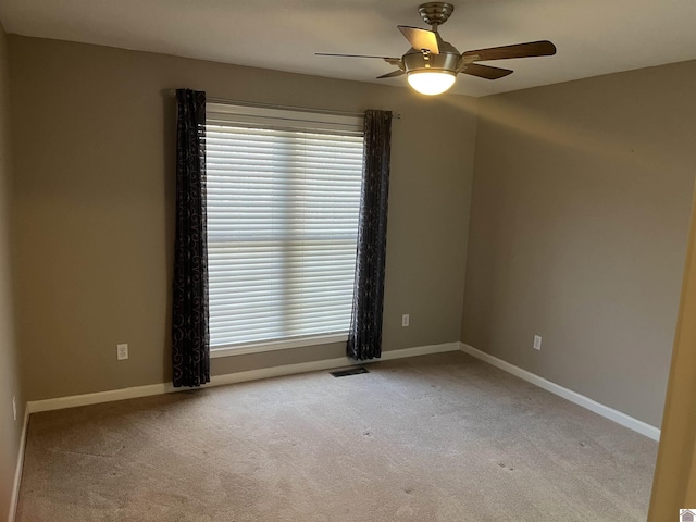 carpeted empty room featuring ceiling fan