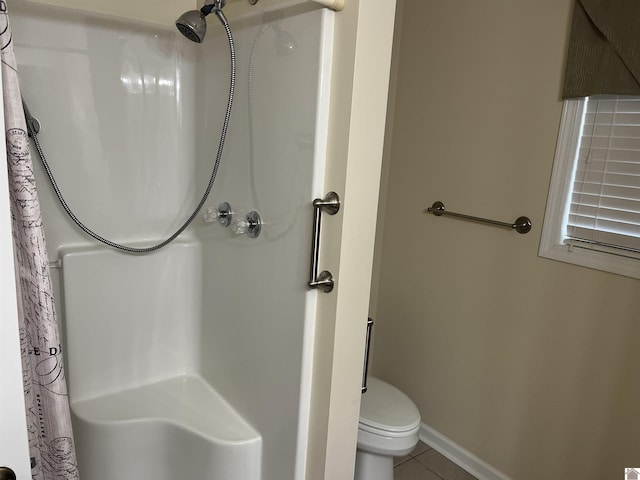 bathroom with tile patterned flooring, curtained shower, and toilet