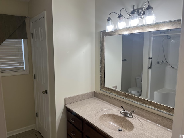 bathroom with vanity, tile patterned floors, toilet, and walk in shower