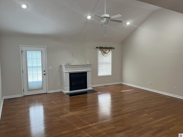 unfurnished living room featuring lofted ceiling, dark wood-type flooring, and ceiling fan