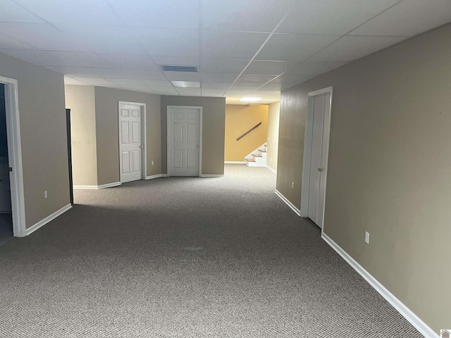 empty room with carpet and a drop ceiling