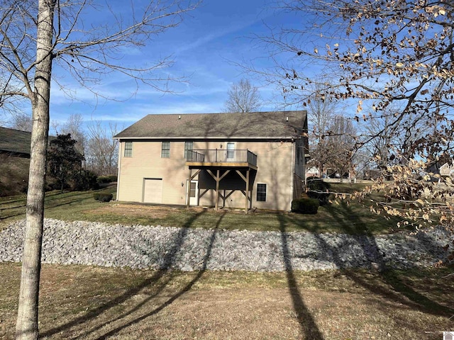 back of house with a deck and a lawn