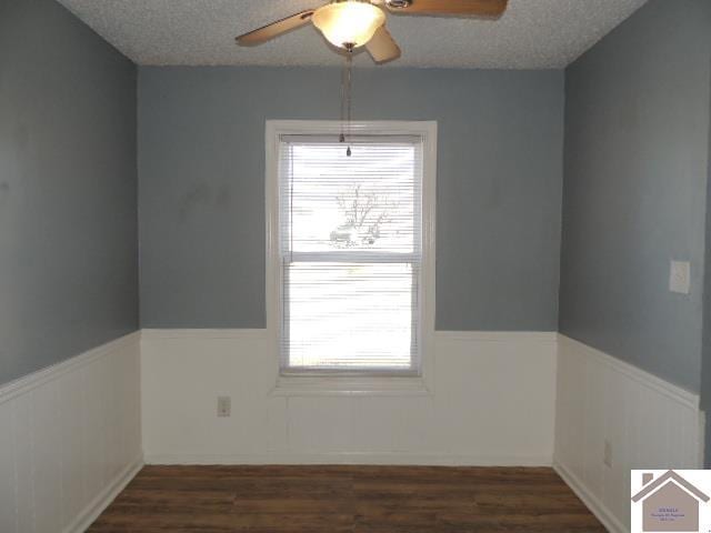 spare room with ceiling fan, dark hardwood / wood-style flooring, and a textured ceiling