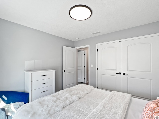 bedroom with a closet and a textured ceiling