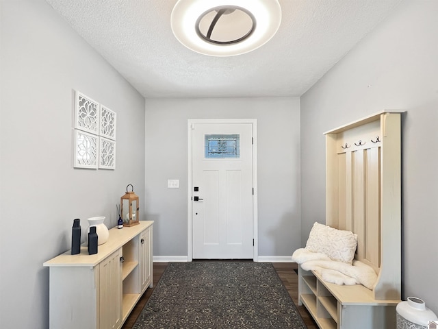 interior space featuring a textured ceiling and dark hardwood / wood-style flooring