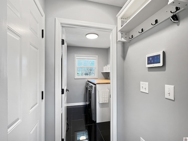 clothes washing area with washing machine and dryer