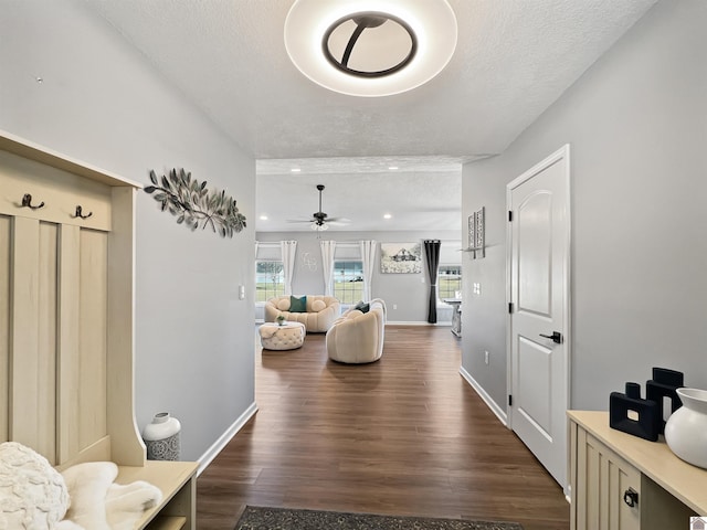 hall featuring dark hardwood / wood-style floors and a textured ceiling