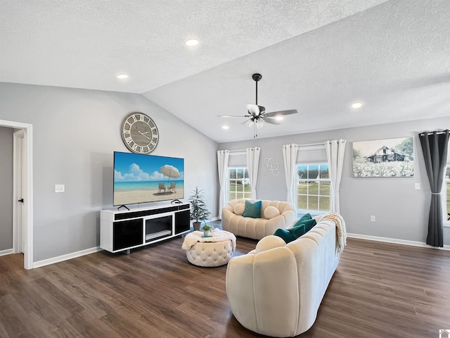 living room with ceiling fan, lofted ceiling, dark hardwood / wood-style floors, and a textured ceiling