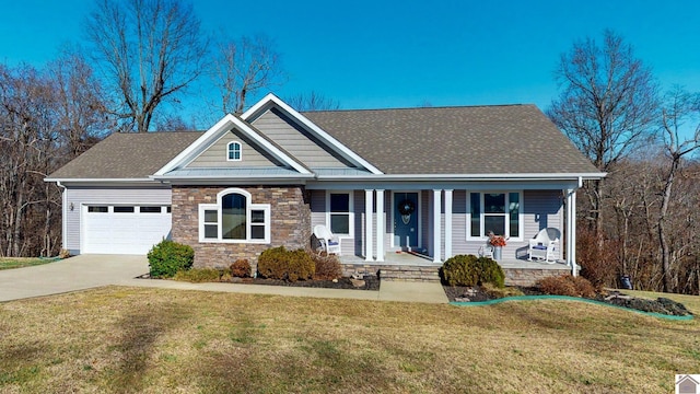 view of front of home with a garage, a front lawn, and a porch