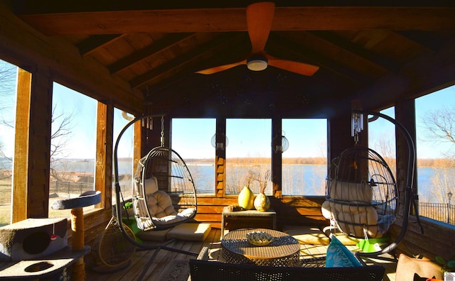 sunroom with wood ceiling, lofted ceiling with beams, ceiling fan, and a water view