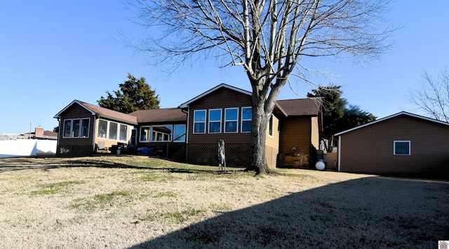 rear view of property featuring a yard