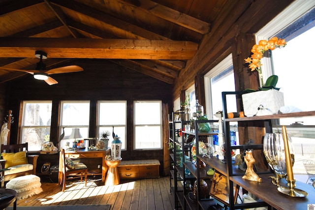 interior space with vaulted ceiling with beams, wooden ceiling, a healthy amount of sunlight, and ceiling fan