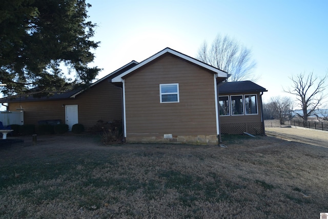 view of side of property with a lawn