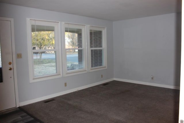 empty room featuring dark carpet