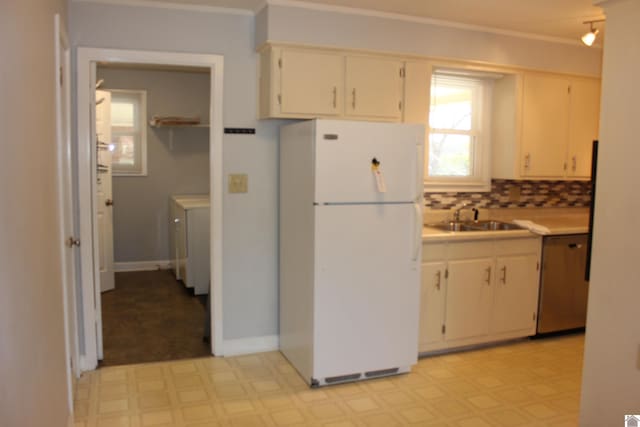 kitchen with a healthy amount of sunlight, sink, dishwasher, and white refrigerator