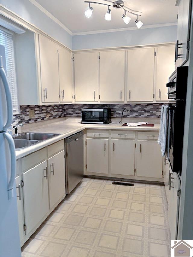 kitchen featuring decorative backsplash, ornamental molding, stainless steel dishwasher, and black oven