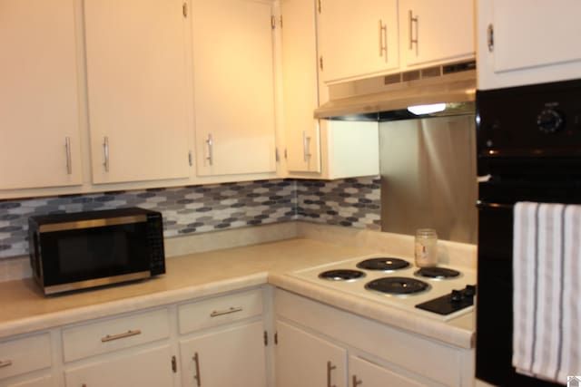 kitchen with white stovetop, oven, and white cabinets